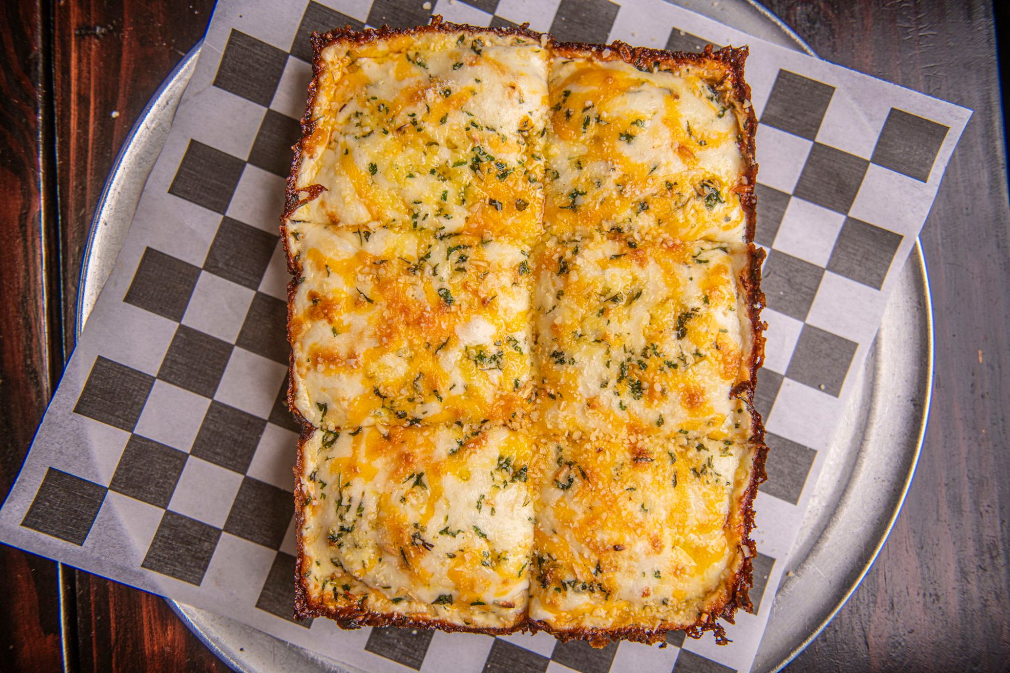 Cheezin' deep dish, all cheese with herbs, cut into six squares